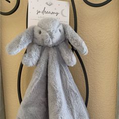 a gray bunny stuffed animal sitting on top of a doorknob next to a sign that says so dreamy