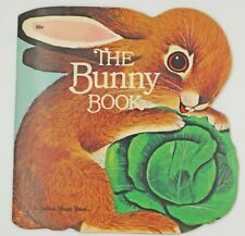 the bunny book with an image of a rabbit holding a leafy green plant in it's mouth