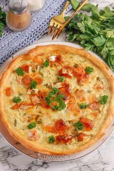 a pizza sitting on top of a pan covered in cheese and toppings next to a fork