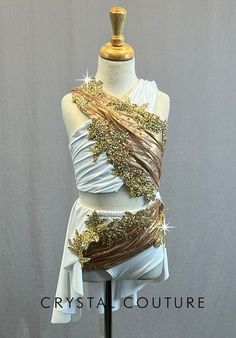 a white and gold dress on a mannequin