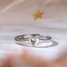 Dainty and delicate, this heart ring makes a little lovely gift for loved one or yourself. Heart is one of the most popular motifs in jewelry that often related with love. Crafted in sterling silver, this band features one heart for an effortless look.This band is a beautiful reminder of your timeless romance.Weight: 2 gWidth: 2.7 mmHeight: 2.3 mmThickness: 1.4 mmMaterial: 925 SilverPlating Color: Silver Dainty Open Heart Ring As Gift, Delicate Heart Charm Ring As Gift, Adjustable Silver Heart Ring For Mother's Day, Dainty Personalized Silver Heart Ring, Sterling Silver Open Heart Ring Gift, Silver Rings As Valentine's Day Gift, Double Heart Ring As A Gift, Adjustable Heart Cut Ring For Valentine's Day, Minimalist Double Heart Ring For Gift