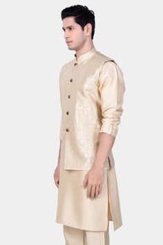 Elevate your style with our Almond Brown Kurta Set paired with a Pearl Bush Cream hexagon Designer Embroidered Nehru Jacket, a stunning ensemble perfect for weddings, engagements, or parties. This casual yet refined set is tailored for men seeking elegance and comfort. The intricately embroidered Nehru jacket adds a touch of sophistication to the ensemble, making it a standout choice for special occasions. Experience luxury and style with this exquisite kurta jacket set. Nehru Jacket In addition to being constructed from Imported Superior Fabrics, French crown Nehru jackets are built with top quality components and thoughtful construction. 100% Recycled Polyester Fabric. Features Semi Padded shoulder for a formal silhouette 5-button, single-breasted closure Mandarin Collar Flap pockets Boa Festive Brocade Kurta With Gold Embroidery, Formal Festive Kurta With Gold Embroidery, Elegant Festive Straight Kurta Outerwear, Elegant Gold Nehru Jacket With Cutdana, Elegant Designer Outerwear For Diwali, Elegant Festive Straight Kurta Nehru Jacket, Elegant Nehru Jacket With Resham Embroidery For Designer Wear, Elegant Designer Nehru Jacket For Diwali, Gold Nehru Jacket With Intricate Embroidery For Festive Occasions