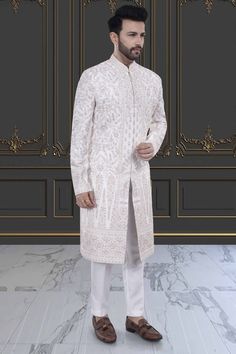 This impeccable sherwani, adorned with luxurious stones and intricate embroidery, exudes sophistication and elegance. Perfect for the stylish groom, it is a timeless masterpiece that will make a lasting impression. Indulge in the opulence and elevate your wedding day look with this R14-S71 sherwani. Mens Sherwani, Intricate Embroidery, Wedding Day, Embroidery