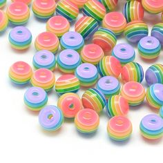 multicolored donuts are scattered on a white surface