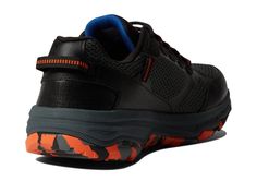 a black and orange sneaker with blue accents on the upper part of the shoe