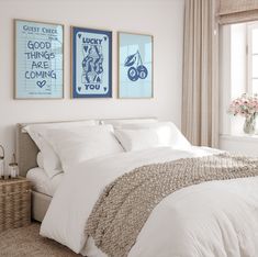 a bedroom with two framed pictures above the bed