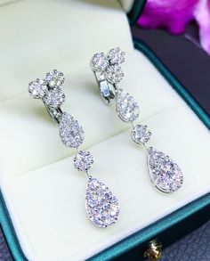 HANDCRAFTED TO PERFECTION! SPECIAL AND LOVELY TEARDROP DESIGN, ILLUSION SETTING (APPEARS TO BE LIKE A 1-2 CARAT BRILLIANT PEAR Diamonds). With over 104 pieces of UNTREATED AND GENUINE F/VS QUALITY SPARKLING DIAMONDS! Perfect for every event! SET IN 18K SOLID WHITE GOLD HANDCRAFTED, DANGLING EARRINGS! SUGGESTED RETAIL VALUE: $9,000 DIAMONDS: 104 ROUND BRILLIANT, FULL CUT with excellent firing diamonds, weighting at 3.14 carats. ALL NATURAL, UNTREATED DIAMONDS. ALL DIAMONDS HAVE NO VISIBLE INCLUSI White Gold Clip-on Diamond Earrings In Sterling Silver, Silver Luxury Clip-on Diamond Earrings, White Gold Sterling Silver Clip-on Diamond Earrings, White Gold Teardrop Chandelier Earrings Fine Jewelry, White Gold Teardrop Chandelier Earrings, Elegant White Gold Pear-shaped Chandelier Earrings, White Gold Clip-on Diamond Earrings With Cubic Zirconia, White Gold Cubic Zirconia Clip-on Diamond Earrings, Clip-on Cubic Zirconia Earrings In White Gold