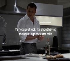 a man standing in a kitchen next to a counter