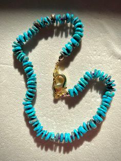 Experience the allure of genuine, untreated, and undyed natural Arizona Turquoise with our luxurious beaded necklace. This stunning piece features 10mm heishi-shaped turquoise beads, meticulously hand-knotted on vibrant purple silk thread to ensure both beauty and durability. Each bead is separated by a secure knot, enhancing the necklace's flexibility and longevity while providing a striking visual contrast. Accented with shimmering gold-filled beads and finished with a sturdy gold-filled lobst Turquoise Rondelle Beaded Gemstone Necklaces, Turquoise Beaded Necklace With Round Gemstone Beads, Turquoise Gemstone Necklace With Round Beads, Turquoise Chrysocolla Necklace With Round Beads As Gift, Blue Single Strand Turquoise Necklace With Chrysocolla, Blue Turquoise Chrysocolla Necklace Single Strand, Turquoise Single Strand Necklace In Amazonite, Turquoise Polished Chrysocolla Beads Jewelry, Turquoise Chrysocolla Jewelry With Polished Beads