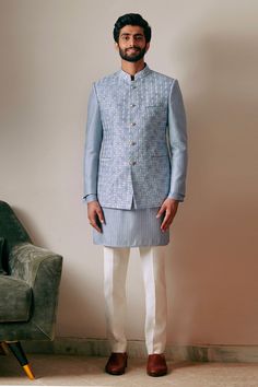 Blue bandhgala with pinwheel embroidery and mandarin collared neckline.
Component: 1
Pattern: Embroidery
Type Of Work: Pinwheel
Neckline: Mandarin collar
Sleeve Type: Full sleeves
Fabric: 100% Silk
Color: Blue
Other Details: 
Front button detailing
Note: Inner kurta and pant worn by the model is not for sale
Occasion: Destination Wedding - Aza Fashions Bandhgala For Men, Mens Kurta Designs, Mens Kurta, Bridesmaid Outfit, Kurta With Pants, Silk Embroidery, Kurta Designs, Full Sleeves, Mandarin Collar