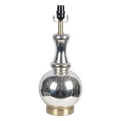 a silver vase with a black top on a gold base and a light bulb attached to it