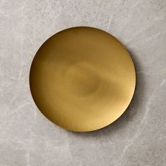 a gold plate sitting on top of a white counter