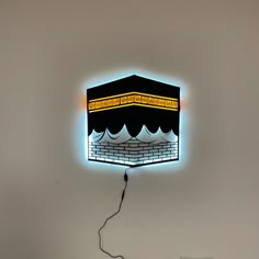 a black and yellow light hanging from the side of a wall