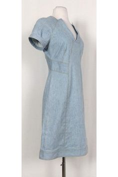 Versatile denim dress featuring a classic semi flared silhouette. The perfect dress to wear to a picnic at the park, pair it with chic sandals and a statement handbag. Size 4 Lined, cotton & elastane blend V-neckline Short sleeves Unlined Flared silhouette Mustard top stitching Above knee Bust 34" Waist 28" Shoulder to hem 37" Fitted A-line Denim Dress For Summer, Fitted Midi-length Denim Dress For Spring, Elegant Midi-length Denim Dress For Spring, Fitted Midi Denim Dress For Spring, Fitted V-neck Denim Dress For Summer, Fitted Mid-length Denim Dress In Medium Wash, Medium Wash Fitted Mid-length Denim Dress, Fitted Mid-length Medium Wash Denim Dress, Elegant Denim Blue Short Sleeve Dress