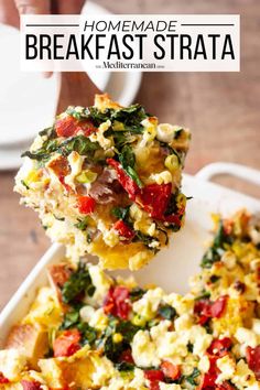 someone is taking a piece of vegetable frittata from a casserole dish