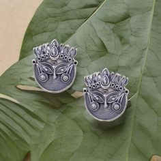 Elevate your style with these exquisite Oxidized Durga Stud Earrings, a perfect blend of artistry and spirituality. Each pair of these stud earrings is meticulously handcrafted to capture the essence of Goddess Durga, the embodiment of strength, courage, and protection. 🌟 Key Features: ✨ Intricate Oxidized Finish: These earrings are meticulously treated with an oxidized finish, creating an antique and timeless look that adds character to your attire. ✨ Durga Inspired Design: The design of these Traditional Earrings With Oxidized Finish, Traditional Earrings With Oxidized Finish And Adjustable, Traditional Oxidized Finish Earrings, Handmade Round Earrings For Navratri, Adjustable Artistic Design Earrings For Gift, Navratri Gift Earrings With Oxidized Finish, Traditional Artistic Design Drop Earrings, Artistic Jewelry For Jewelry Making And Festivals, Adjustable Nickel-free Earrings For Festive Occasions