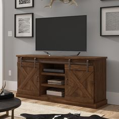 a flat screen tv mounted to the side of a wooden entertainment center in a living room