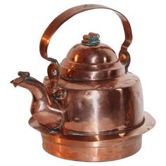 a copper tea kettle with a horse on it