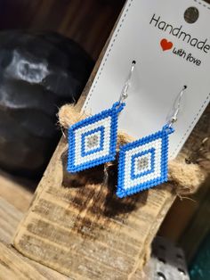 Beaded blue and white diamond shaped earrings. Handmade Blue Geometric Earrings, Handmade Blue Geometric Jewelry, Beaded Leather Bracelet, Diamond Shape Earrings, Metal Cuff Bracelet, Bead Leather, Diamond Shaped, Blue Beads, White Diamond