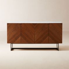 a wooden cabinet with marble top and metal legs