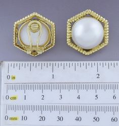 Presented is a lovely pair of 18 karat gold and pearl earrings. These are relatively modern earrings, likely made in Italy or elsewhere in Europe. The earrings are done in a hexagonal style, each set with a beautiful mabe pearl of about 18.5 millimeters in diameter. The gold settings are heavy and high quality, done in a ribbed design. The earrings have omega style clipbacks for wear with unpierced or pierced ears, but a jeweler could easily add posts so the earrings could be worn specifically f Elegant Octagon Earrings For Formal Occasions, Elegant White Octagon Earrings, Luxury Gold Octagon Earrings, Elegant Octagon Wedding Earrings, Elegant Hexagon Earrings For Gift, Gold Octagon Earrings For Wedding, Gold Octagon Wedding Earrings, Elegant Gold Hexagon Earrings, Elegant Gold Hexagon Jewelry