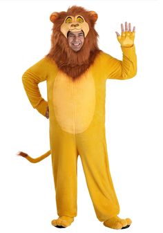 a man in a lion costume standing with his hand up to the side and wearing a mask