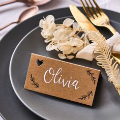 a place card on a plate with silverware