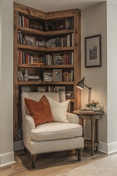 a white chair sitting in front of a book shelf filled with books