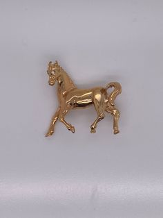 "Vintage 14k yellow horse pin with a diamond set in the eye. The pin measures 1.25\" long and weighs 8.19 grams of gold. The pin can be converted into a charm or pendant if desired." Classic Gold Jewelry With Horse Design, Collectible 14k Gold Brooches, Yellow Horse, Horse Brooch, Gold Horse, Diamond Set, The Eye, Equestrian, Brooch Pin