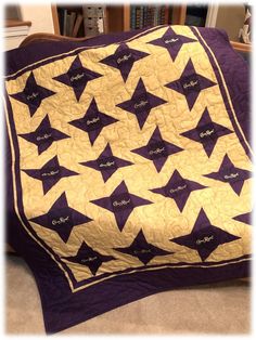 a purple and yellow quilt with stars on it