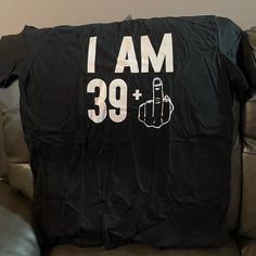 a black t - shirt that says i am 39 plus with a hand pointing up