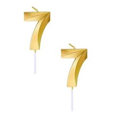 two gold earrings with white sticks in the shape of numbers