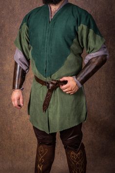 our expertly handcrafted Elven tunic dresses, designed to captivate in every detail. Whether you're a cosplayer, filmmaker, or an enthusiast of fantasy realms, these enchanting dresses are the perfect choice for bringing your Elven fantasies to life. Material: Indulge in the luxurious touch of 100% cotton, complemented by authentic medieval fabric. Each thread tells a tale, ensuring comfort and an immersive experience into the magical world of forest elves. Inclusions:     Green Tunic Dress with Medieval Cosplay Costume For Festivals, Viking Costume For Medieval Festivals, Medieval Style Costumes For Cosplay At Medieval Festivals, Viking Medieval Festival Costume, Elven Style Medieval Dress For Cosplay, Fantasy Long Sleeve Cosplay Costume For Larp, Long Sleeve Fantasy Cosplay Costume For Larp, Elven Style Medieval Dress For Cosplay With Long Sleeves, Fantasy Long Sleeve Medieval Dress For Festivals