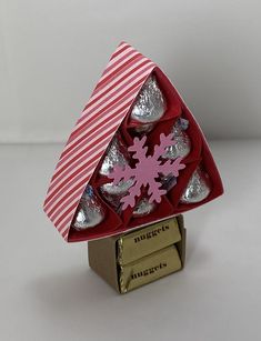 an ornament shaped like a christmas tree with herspoos in it's box