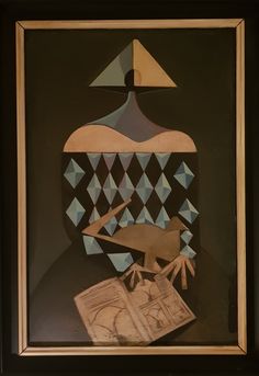 an abstract painting with geometric shapes on black and white paper, framed in gold frame