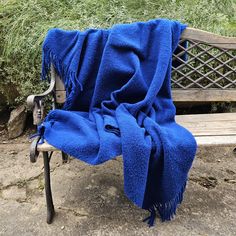 a blue blanket sitting on top of a wooden bench