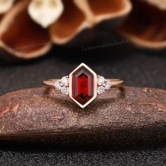 Art Deco Garnet Engagement Rings Hexagon Cut Garnet Promise Ring Vintage Moissanite Rings for Women Rose Gold Wedding Ring Anniversary Gifts RING DESCRIPTION ✦Engagement Ring ✴Center Stone - Garnet Shape - Hexagon Cut Size - 6*9mm ✴Side Stones - Moissanite Shape - Round Cut Weight - 0.19CT ✴Band Width - About 1.6mm ✴Ring Metal: Available in rose gold plated, yellow gold plated, 925 sterling silver, 10k or 14k solid rose, yellow or white gold. MAKING & SHIPPING ✦PAYMENT PLAN ♡ We provide layaway Emerald Cut Garnet Anniversary Ring, Octagon Diamond Wedding Ring With Prong Setting, Wedding Jewelry With Rose Cut Diamonds And Garnet, Elegant Octagon Ruby Ring For Gift, Wedding Asscher-cut Diamond Ring With Bezel Setting, Emerald Cut Ruby Ring With Bezel Setting, Asscher Cut Diamond Ring With Bezel Setting For Wedding, Emerald Cut Garnet Jewelry For Weddings, Garnet Jewelry With Bezel Setting For Wedding