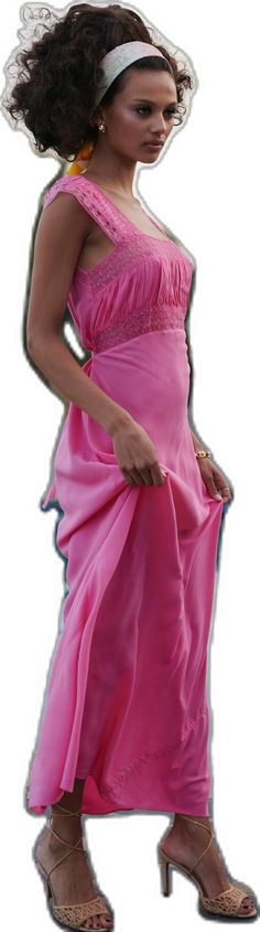 a woman in a pink dress and headband