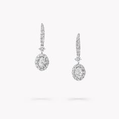 A gleaming pavé diamond halo frames two elegant centre stones in our Icon earrings in white gold, enhancing the captivating play of light that emanates from deep within the oval diamonds. Suspended from graceful pavé clips, the diamond detailing is designed to scintillate with the wearer's every movement. Named after the famous Icon diamond – a 90.97 carat round brilliant diamond that was cut and polished by Graff in 2000 – the Icon collection celebrates the incomparable beauty of one of Mother’ Oval Diamond Earring, Graff Diamonds, Icon Jewelry, Round Diamond Pendant, Round Diamond Earrings, Pave Diamond Earrings, Diamond Earrings Studs Round, Yellow Engagement Rings, Fine Diamond Jewelry