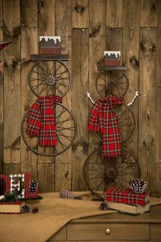 two christmas decorations on display in front of a wooden wall