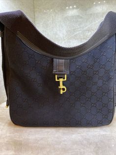 Gucci shoulder bag black GG canvas with leather trim,gold hardware,nylon lining,single interior pocket,clasp closure,shoulder strap,mint condition,sold elsewhere.. With 12,hight12 on the highest point,8 in the middle,,3 deep,about 20-shoulder strap. Gucci Shoulder Bag, Shoulder Bag Black, Canvas Leather, Leather Trim, In The Middle, Leather Trims, Gold Hardware, Mint Condition, Shoulder Strap