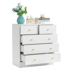 a white dresser with three drawers and a vase on top of it, against a white background