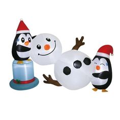 three inflatable snowmen with hats on their heads