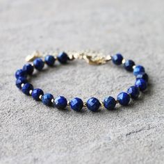 This gorgeous dark blue Lapis Lazuli gemstone bracelet features 18K gold filled accents. Stone: Lapis Lazuli Colour: Dark Blue Main Stone Size: 6mm round  Metal: 18K Gold Filled Length: 19 - 24cm (with extension chain) I love making beautiful, handmade one-of-a-kind pieces of jewellery using semi-precious natural stones and crystals that can be treasured for a lifetime. I can customise a design specifically to meet your needs with your favourite semi-precious stones - ask about a custom design to match a special outfit or for your wedding or bridesmaids. Gemstone Earrings Dangle, Semi Precious Stone Bracelet, Dragon Vein Agate, Lapis Lazuli Gemstone, Blue Lapis Lazuli, Pretty Pendant, Teardrop Dangle Earrings, Blue Lapis, Labradorite Stone