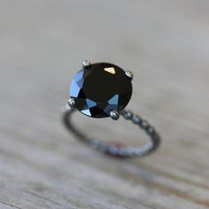 Black Spinel Solitaire Ring with Recycled AS WELL as Recycled Sterling Silver. This ring is given an oxidized finish to Blacken the silver. Oxidation wears over time but can be reapplied - just write us on how to :) For the Bright Polished Silver Version of this ring click here https://www.etsy.com/listing/172794808/black-spinel-ring-black-stone-ring?ref=shop_home_active_2&ga_search_query=black%2Bspinel. Spinel is a Precious stone, along with Rubies, Sapphires, Emeralds and Diamonds, but is perh Xoxo Necklace, Silver Door, Spinel Jewelry, Black Spinel Ring, Gold Flower Ring, Black Engagement Ring, Black Stone Ring, Winter Typ, Silver Cocktail