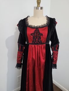 U.S. dress size 4-8 (medium). Italian renaissance 1490's style dress made from black velvet and red silk.  Adjustable lace back for a perfect fit.  Dress front features lace applique with hand beadwork. The lower sleeves are detailed with hand embroidery and glass beads.  Bust: 33"-40" Underbust: 33"-36" Underbust to hem: 42" Black Fitted Medieval Dress Costume, Fitted Victorian Dresses For Theater, Red Fitted Victorian Dress For Evening, Fitted Red Victorian Dress For Evening, Red Fitted Vintage Medieval Dress, Red Vintage Fitted Medieval Dress, Fitted Red Vintage Medieval Dress, Vintage Red Fitted Medieval Dress, Elegant Medieval Festival Costume Dress