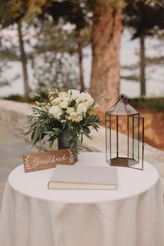 an image of a table with flowers and a book on it that says, i do not know what this photo is