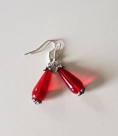 Handmade red long teardrop style,with antique silver caps.  1 1/8 inches long Dress Earrings, Dangle Earrings Wedding, Earrings Teardrop, Silver Caps, Yellow Earrings, Sparkle Earrings, Long Red, Earrings Wedding, Gift Jewelry