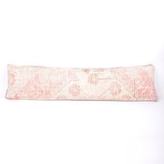 a pink and white decorative pillow on a white background