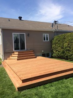 a large wooden deck in front of a house